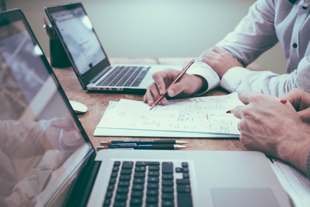 HR professional reviewing recruitment documents and candidate profiles at desk